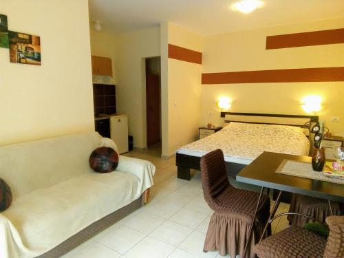 a bedroom with a bed and a table and chairs at Apartment Vila MM Srce in Vrdnik