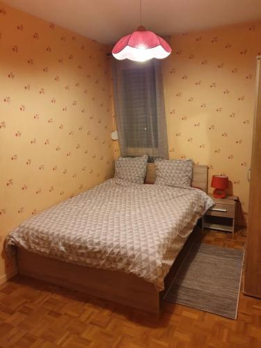a bedroom with a bed with a white comforter at Dans grand appart de 113m2 proche Paris in Creil