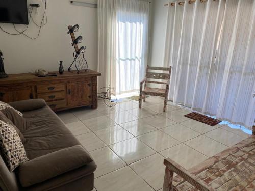 a living room with a couch and a chair at Pousada Nova Estrela da Canastra in Delfinópolis