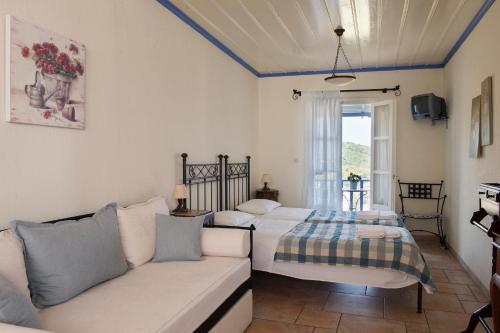 a living room with two beds and a couch at Chiliadromia Studios in Alonnisos Old Town