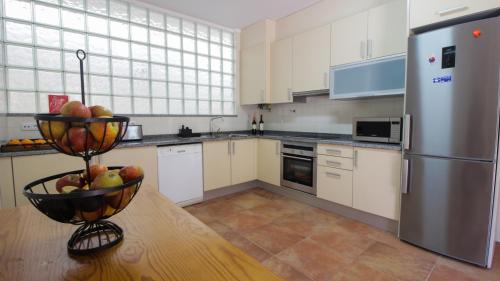 a kitchen with a bowl of fruit on a table at River house in Vila Nova Cerveira in Vila Nova de Cerveira