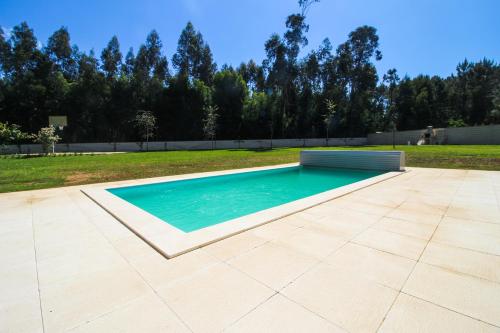 a swimming pool in the middle of a yard at River house in Vila Nova Cerveira in Vila Nova de Cerveira