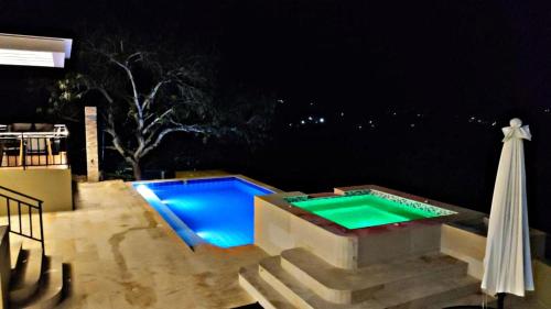 a swimming pool at night with an umbrella at Mountain View Anapoima in Anapoima