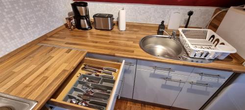 a kitchen with a counter with a sink and a sink at Süße kleine Ferienwohnung in Pirna
