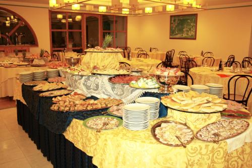 a table with many plates of food on it at Park Hotel Villa Americana in Rodi Garganico
