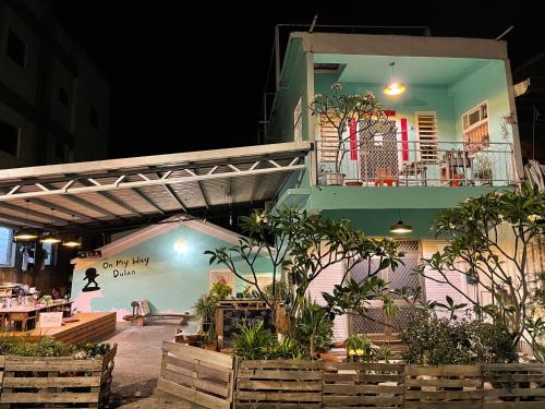 a building with a balcony and a patio with plants at On My Way Dulan in Donghe