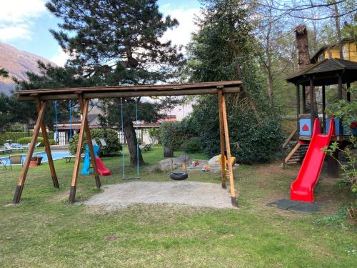 a playground with a swing set and a swing set at Garni Villa Siesta Park in Losone