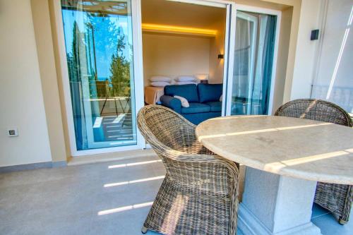 a table and chairs in a living room with a couch at Paleopetres K-Nine - Premium Suite - Kalami - in Kalami