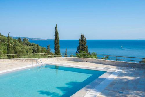 a swimming pool with a view of the ocean at Paleopetres K-Nine - Premium Suite - Kalami - in Kalami