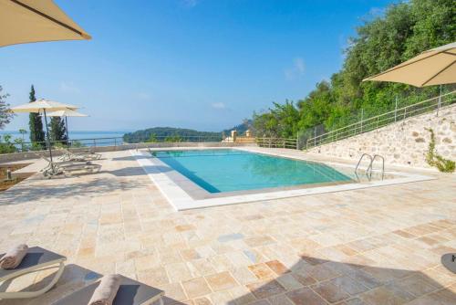 a swimming pool with a view of the ocean at Paleopetres K-Nine - Premium Suite - Kalami - in Kalami