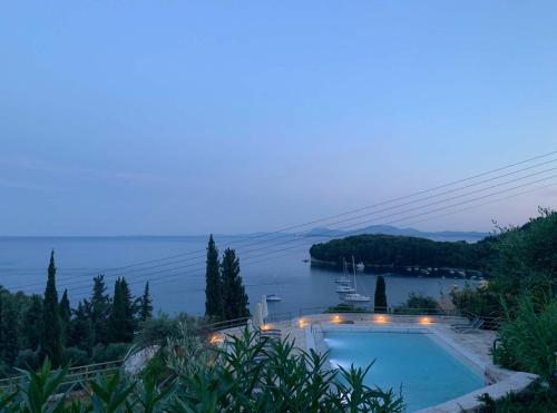 a swimming pool with a view of a body of water at Paleopetres K-Nine - Premium Suite - Kalami - in Kalami