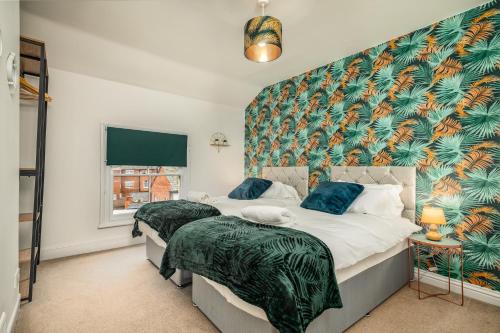 a bedroom with two beds and a large window at LARGE Town Centre Townhouse for Work and Leisure inc Private Parking in Northampton