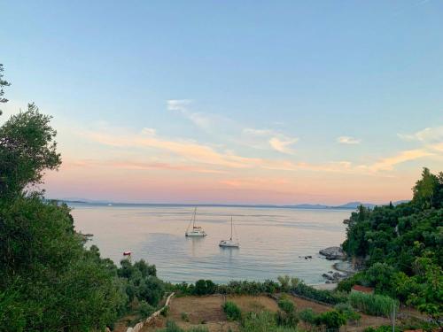two boats in the water at sunset at Paleopetres K-Nine - Premium Suite - Kalami - in Kalami