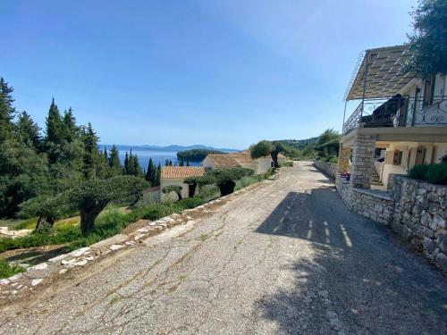 a gravel road next to a house and a building at Paleopetres K-Nine - Premium Suite - Kalami - in Kalami
