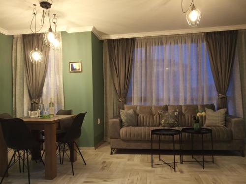a living room with a couch and a table at Bayview apartments Todorov in Burgas City