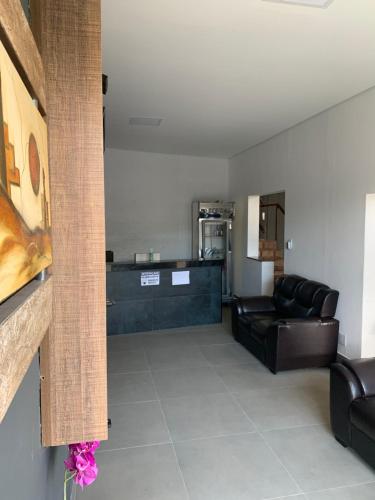 a living room with a couch and a table at Hotel JK Buenópolis in Buenópolis