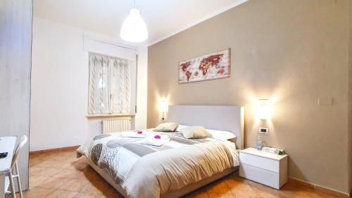 a bedroom with a bed and a table and a window at Guest Holiday Piave 1 in Reggio Emilia