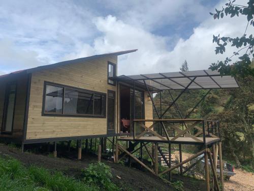 a house being constructed with a roof and a deck at Mirador Bosque Gran Torino Neusa in Cogua
