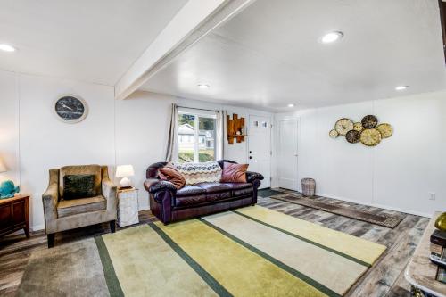 a living room with a couch and a chair at Fisherman's Dream Boat House in Garibaldi