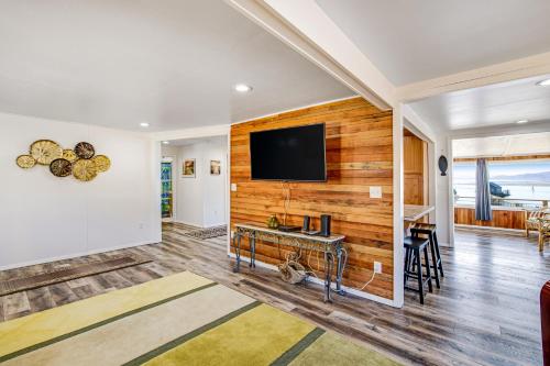 a living room with a flat screen tv on a wall at Fisherman's Dream Boat House in Garibaldi