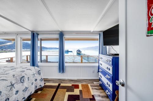 a bedroom with a bed and a large window at Fisherman's Dream Boat House in Garibaldi