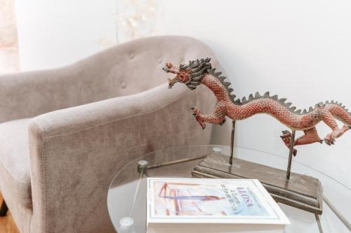 a glass table with two dragon figurines on a couch at Authentic Porto Apartments in Porto