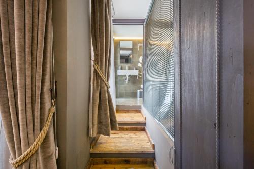 a hallway with a wooden floor and a window at I Mori - Design Apartments in Comiso