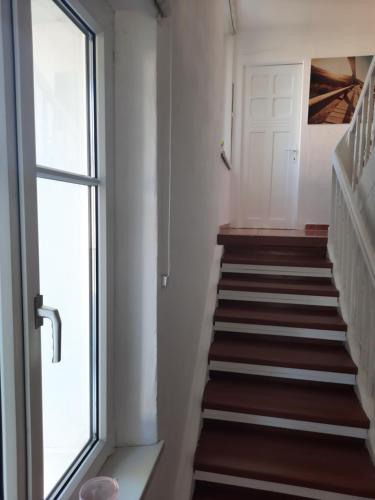 a staircase in a house with a window at Green Hill Apartments - Feldkirch in Feldkirch