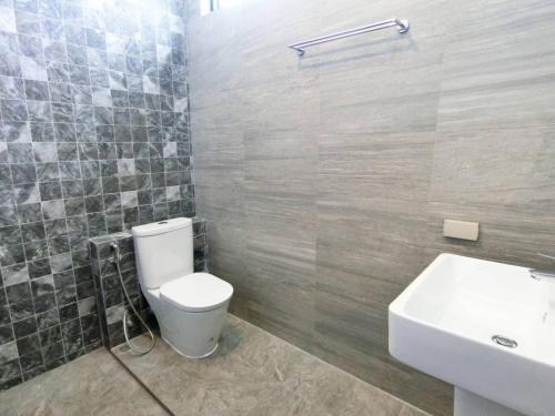 a bathroom with a white toilet and a sink at Lux9 Private Pool Villa HuaHin in Hua Hin