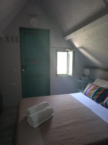 a bedroom with a bed with two towels on it at Sunseabeach in Marzamemi