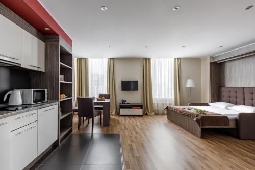 a hotel room with a bed and a kitchen at Vertical Aparthotel in Saint Petersburg