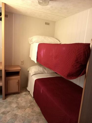 two bunk beds in a small room with a table at Sunseabeach in Marzamemi