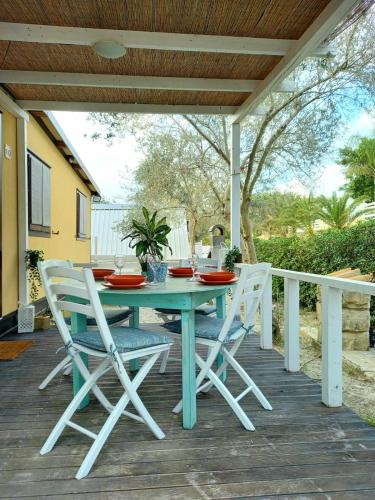 a blue table and chairs on a deck at Sunseabeach in Marzamemi