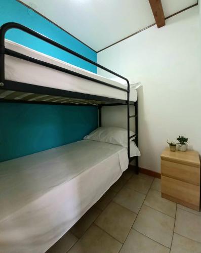 a bedroom with two bunk beds and a table at Sunseabeach in Marzamemi