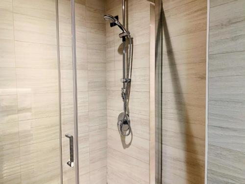 a shower with a glass door in a bathroom at Hotel Astrid in Milan