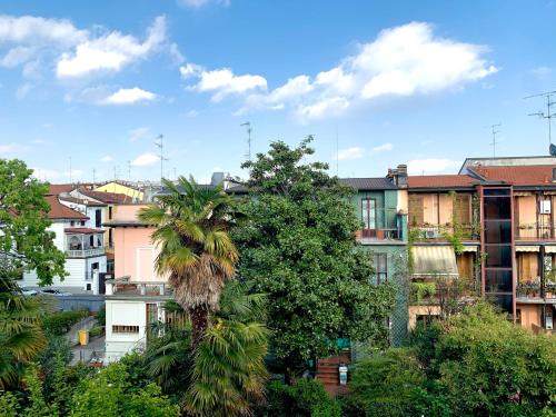 a palm tree in a city with buildings at Hotel Astrid in Milan