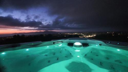 a view of a swimming pool at night at White House in Paraparaumu