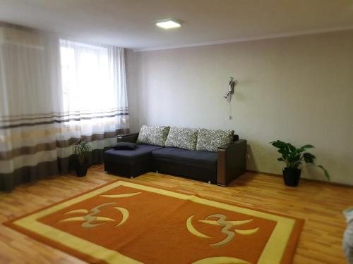 a living room with a couch and a rug at Аpartments on the main street in Bălţi