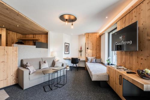 a living room with a couch and a tv at s'Hoamatl Dorfkrug Appartements in Seefeld in Tirol