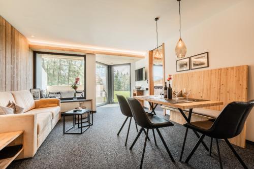 a living room with a table and chairs and a couch at s'Hoamatl Dorfkrug Appartements in Seefeld in Tirol