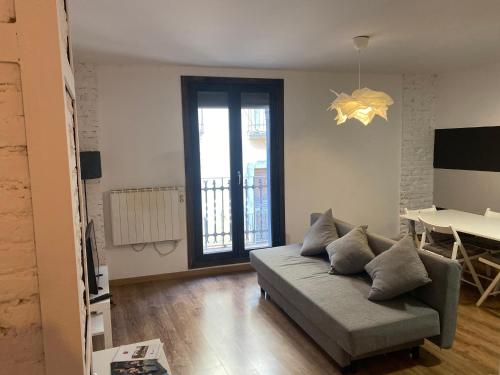 a living room with a couch and a table at Apartamento Casa Latre in Barbastro