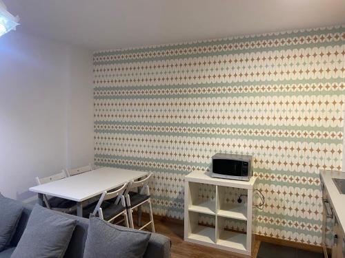 a living room with a table and a wall at Apartamento Casa Latre in Barbastro