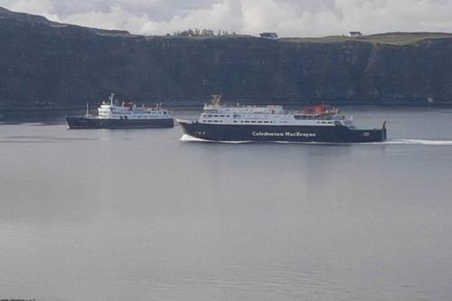 two cruise ships in a body of water at Uig Chalets Idrigill Hill Chalet in Uig