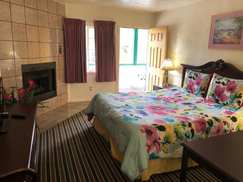 A bed or beds in a room at Monterey Pines Inn