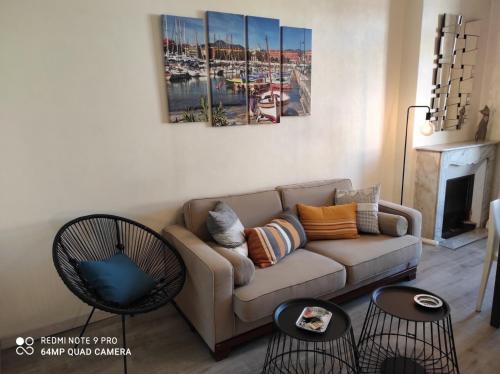 a living room with a couch and two tables at Pretty and quiet top floor 2 bedroom flat in the port area of Nice in Nice