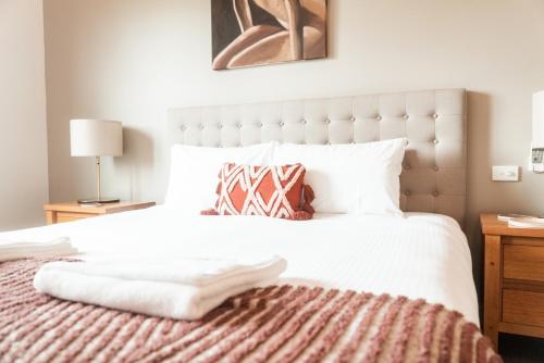 a bedroom with a large white bed with a blanket at Idyllic Loft in the heart of Lovedale in Lovedale
