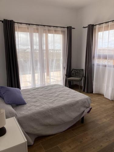 a bedroom with a large bed and a window at Rosa de la laguna in Lajares