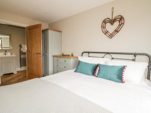 a bedroom with a bed with a heart on the wall at Owl's Hoot in Hull