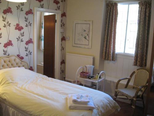 a bedroom with a bed with towels on it at The Red Lion Hotel in Bredwardine