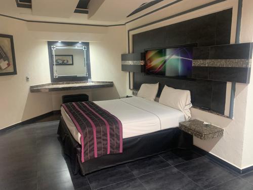 Säng eller sängar i ett rum på Motel Xcaret